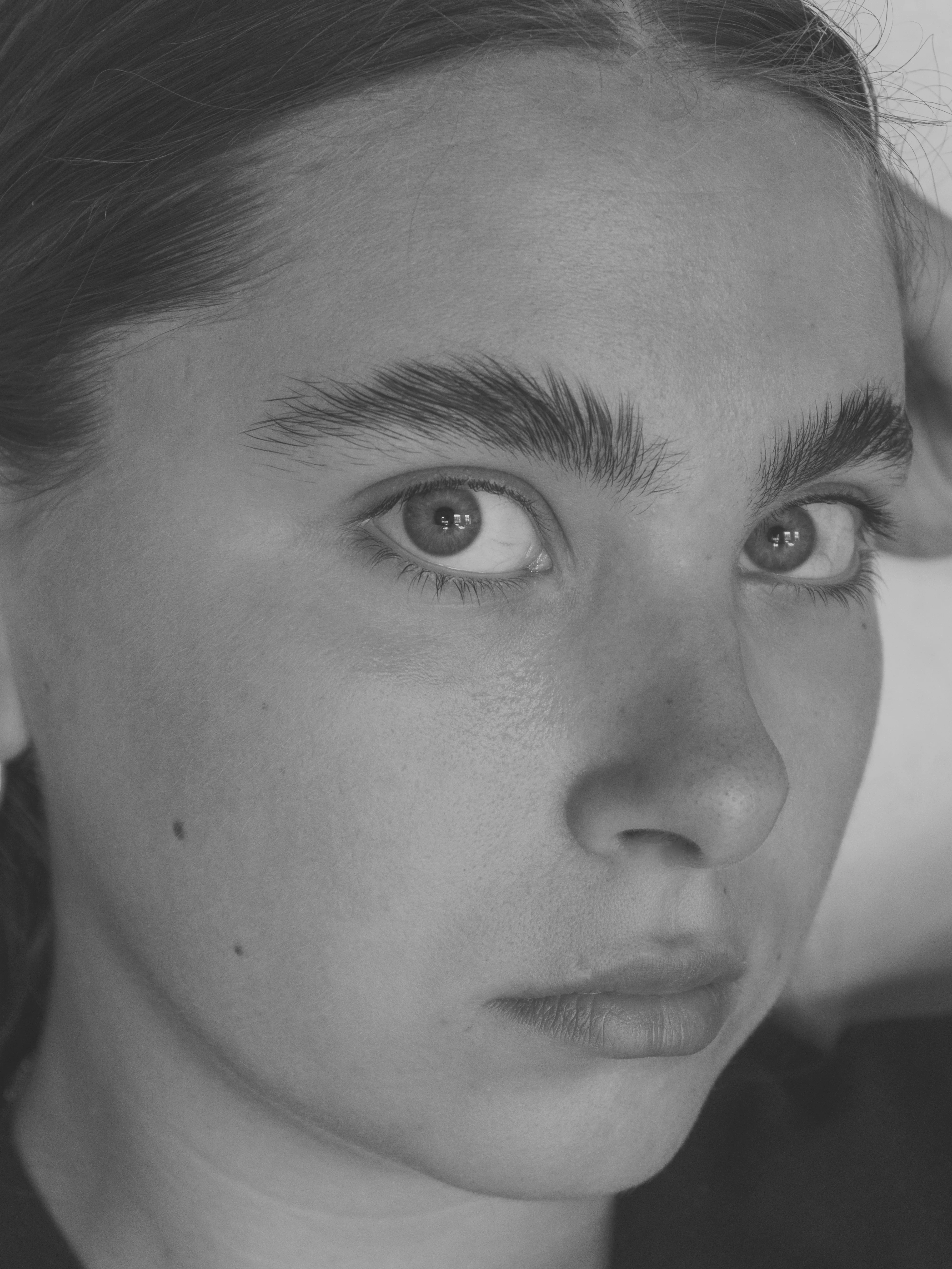 Close-up portrait of young woman with intense gaze
